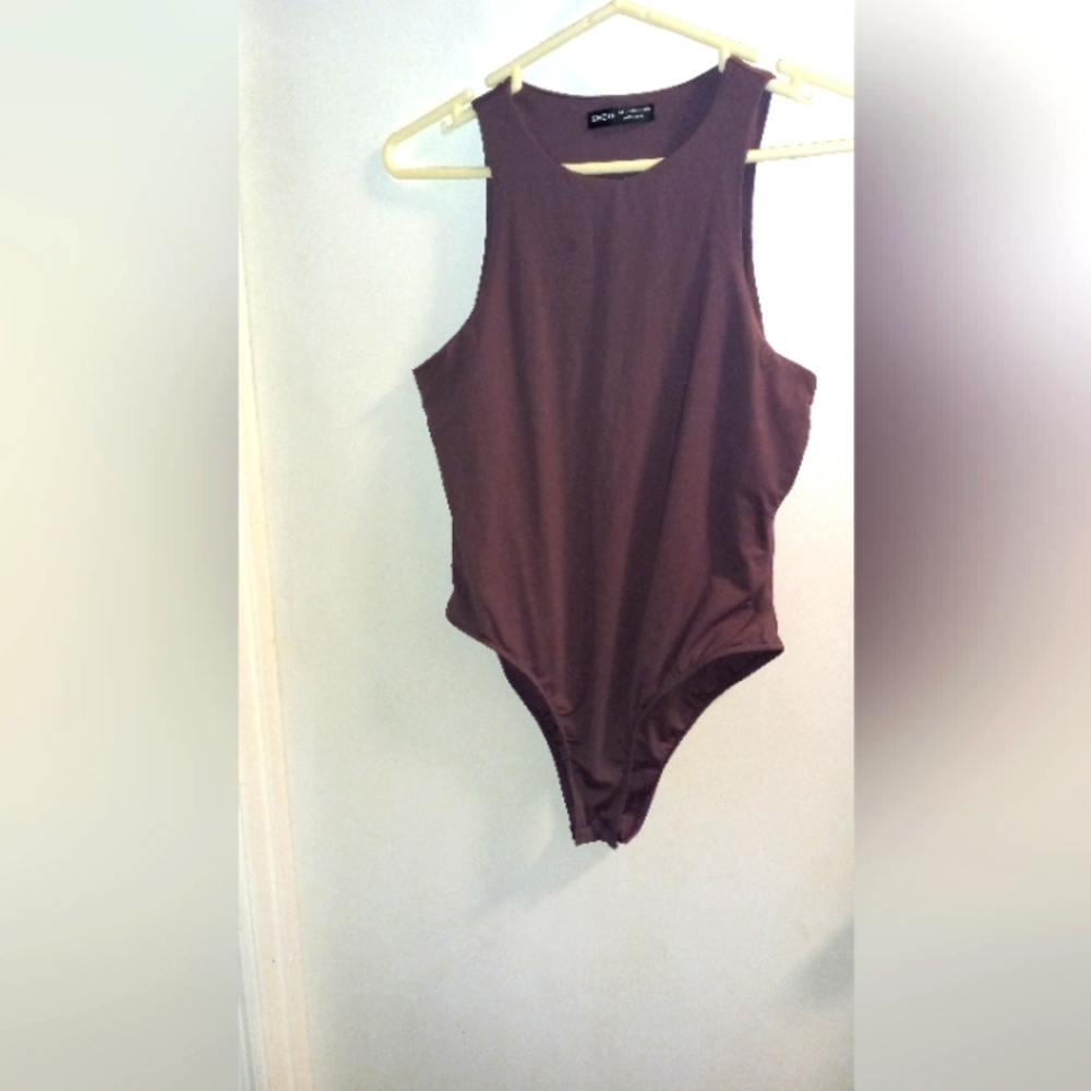 Purple stretchy bodysuit can also be worn as a bathing suit